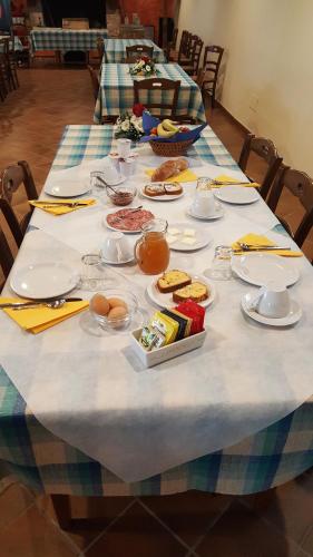 a long table with plates of food on it at Agriturismo Il Palazzone in Montegalda