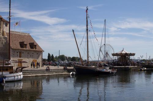 a group of boats docked in a harbor with a roller coaster at Honfleur house in Honfleur