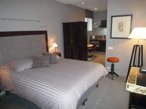 Un dormitorio con una cama grande y una cocina. en La Villa Carat Croix, en Croix