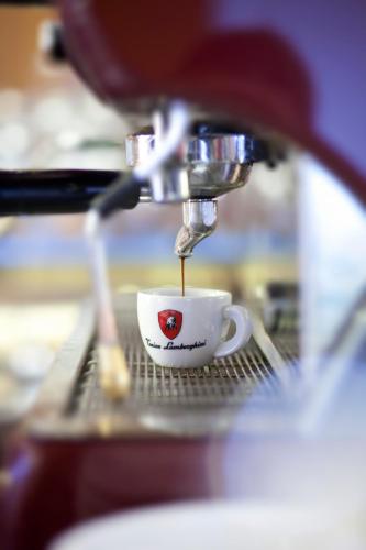 a cup of coffee is being brewed at Grund Resort Golf and Ski in Mladé Buky