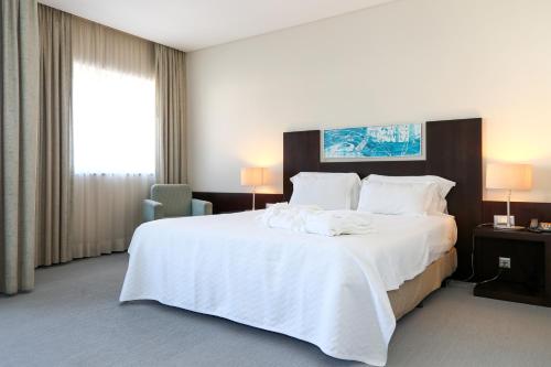 Ένα ή περισσότερα κρεβάτια σε δωμάτιο στο Hotel Praia
