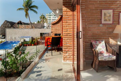 a patio with a table and chairs on a balcony at Vallarta Shores Beach Hotel in Puerto Vallarta