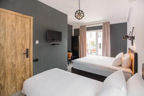 Postel nebo postele na pokoji v ubytování Timber Boutique Hotel