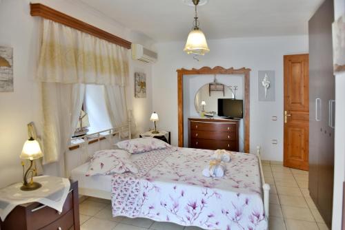 a bedroom with a bed and a mirror at Kassandra House in Hydra