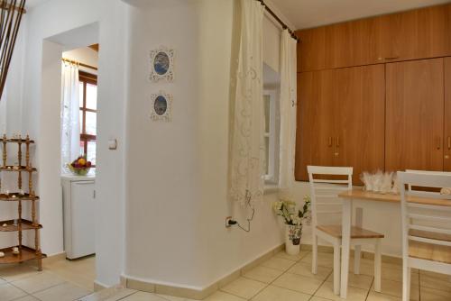 a kitchen with a door leading to a dining room at Kassandra House in Hydra