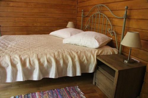 a bedroom with a bed and a table with a lamp at Bird Valley in Sinyak