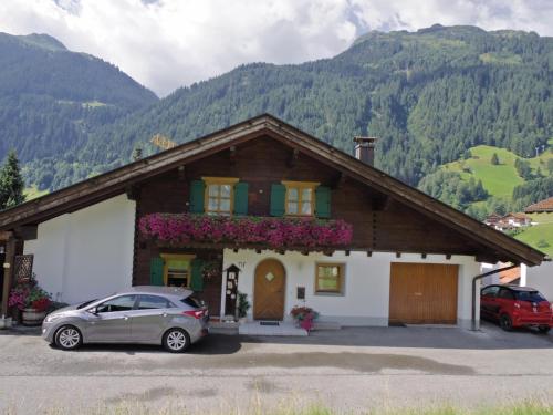 a house with a car parked in front of it at Aparthaus Bianca in Gaschurn