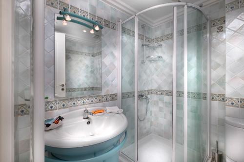 a bathroom with a sink and a shower at Sounio Villa in Sounio