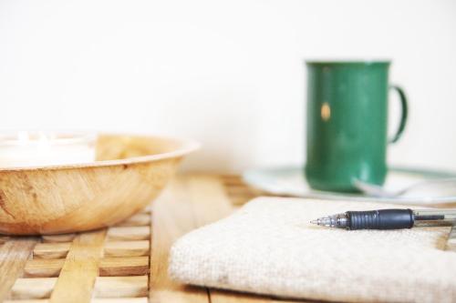 a pen sitting on a table next to a bowl at Fossardalur Guesthouse in Djúpivogur