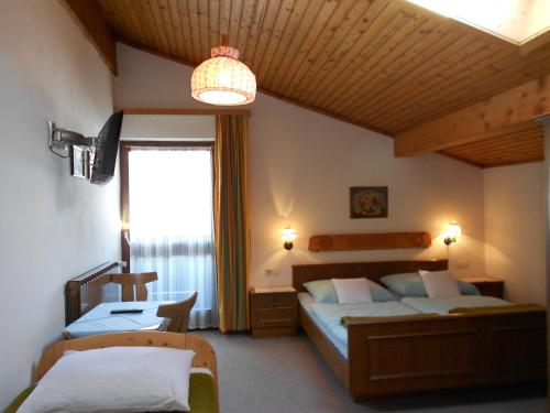 a bedroom with two beds and a large window at Pension Thorerhof in Haus im Ennstal