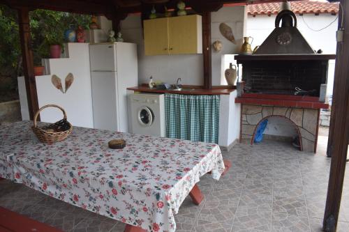 a kitchen with a table and a stove and a oven at House Evristhenis 1 in Toroni