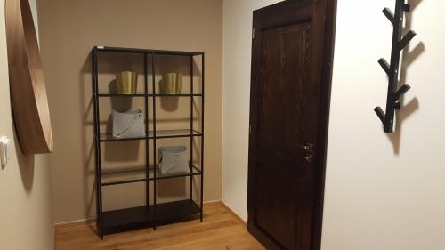 a glass shelf in a room next to a door at The Gusto apartmán in Chomutov