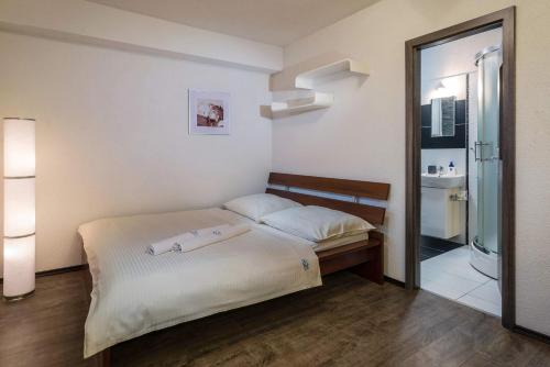 a bedroom with a bed and a glass shower at Apartmany Tilia in Nová Lesná