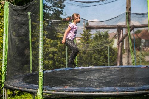 a young girl standing on top of a trampoline at Penzion Fako in Liptovský Mikuláš