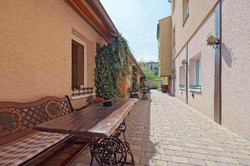a wooden bench sitting on the side of a building at Penzion U Paroháče in Prostějov