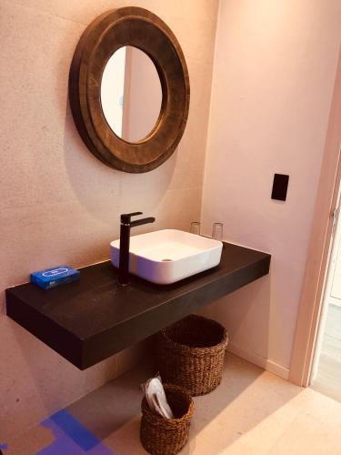 a bathroom with a sink and a mirror on the wall at Abacus Suites in Ayia Napa