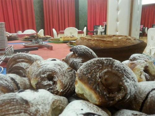 a table topped with lots of different types of donuts at Hotel La Rosa dei Venti in Monte San Giusto