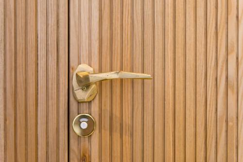 a metal door knocker on a wooden wall at Horti 14 Borgo Trastevere Hotel in Rome