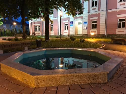 a pool in the middle of a courtyard at night at Apartment Kristina in Otočac