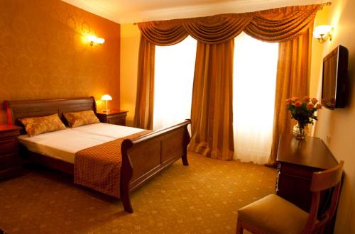 a hotel room with a bed and a window at Hotel Kolegiacki in Poznań