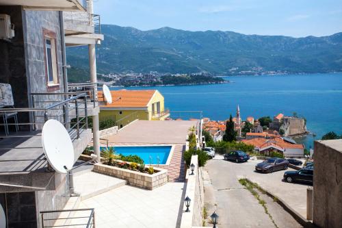 a house with a balcony with a view of the water at Vidikovac Marble House in Budva