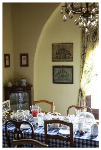 a dining room table with a blue and white table cloth at Al Giardino Degli Etruschi in Chiusi