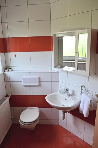 a bathroom with a toilet and a sink at Apartments Dragun in Podstrana