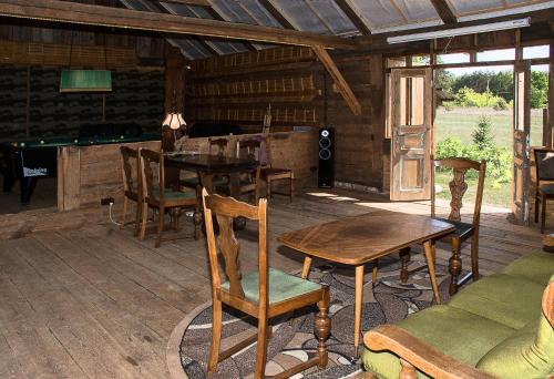 a room with tables and chairs and a pool table at Grenlanda in Ulanów
