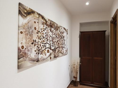 a painting hanging on a wall in a room at La casa del gnocco in Masone