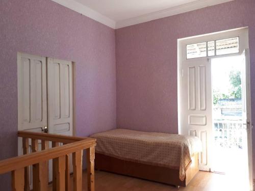 a small bedroom with a bed and a window at Guesthouse Luka in Martvili