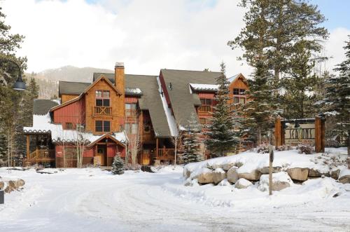 a large log cabin in the snow with a driveway at Lakeside Village by Keystone Resort in Keystone