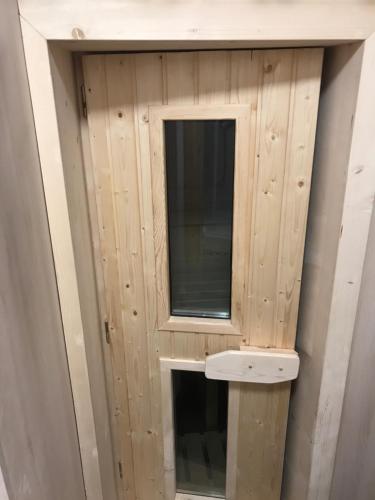 a wooden wall with a window in a room at Chalet6harrachov se saunou in Harrachov