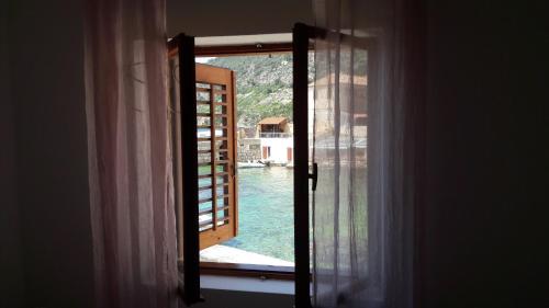 an open window with a view of a pool at Anka's Beach in Komiža