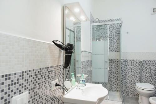 a bathroom with a toilet and a sink and a shower at San Vito Lo Capo da Ciccio in San Vito lo Capo