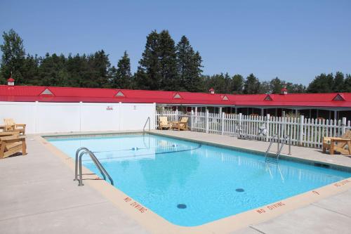 a large swimming pool in front of a building at Mackinac Lake Trail Motel in Mackinaw City