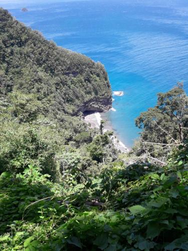 a view of the ocean from a mountain at carré coco in Sainte-Luce