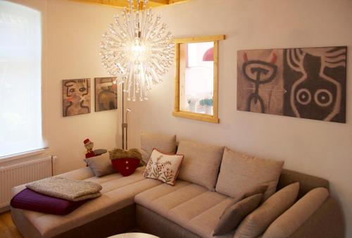 a living room with a couch and a chandelier at Großstrasse 18 B in Leer