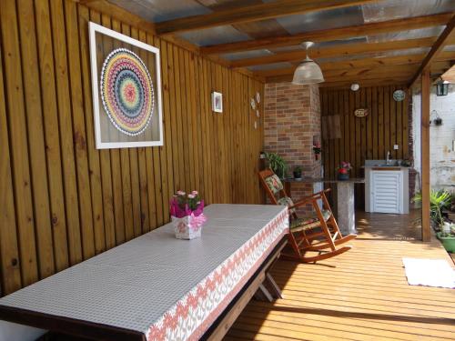 a table on a wooden deck with at Residencial Recanto Paraíso BC - Flat in Balneário Camboriú