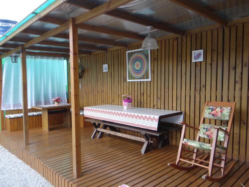 a room with a table and a chair in it at Residencial Recanto Paraíso BC - Flat in Balneário Camboriú