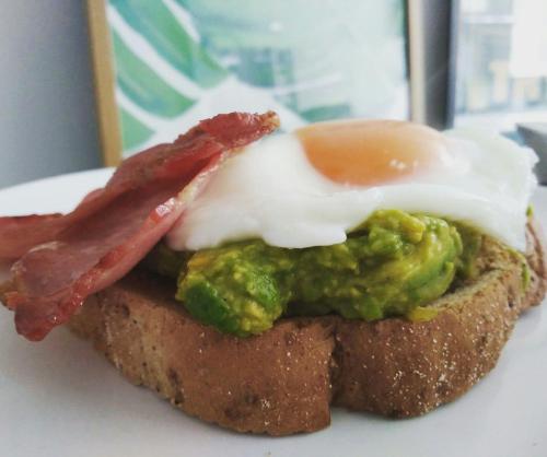 a piece of bread with an egg and bacon on it at Sleep, Eat, Repeat Bed and Breakfast in Macclesfield