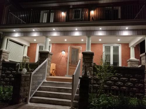 a house with a staircase leading to the front door at Ambassador's Inn Next Door in Stratford