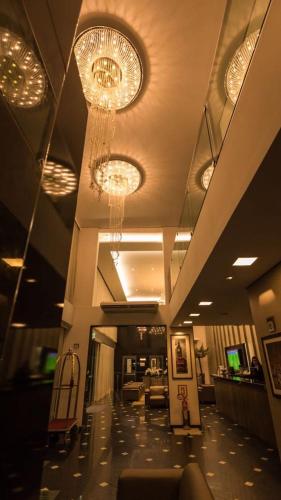 a large lobby with chandeliers and a waiting room at Oscar Hotel Executive in Porto Velho