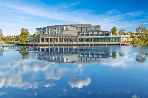 a building sitting on top of a large body of water at Best Western Plus North Lakes Hotel in North Lakes