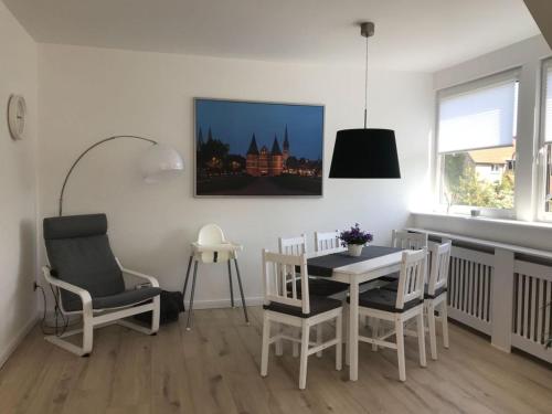 ein Esszimmer mit einem Tisch, Stühlen und einem Fenster in der Unterkunft Ferienapartment Kischa in Scharbeutz