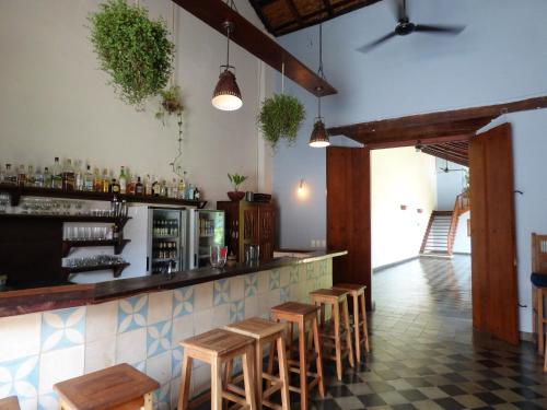 a bar with a row of stools in a restaurant at Hotel con Corazón Granada in Granada