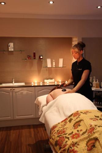 a woman standing next to a woman sitting on a bed at Best Western Kings Manor in Edinburgh