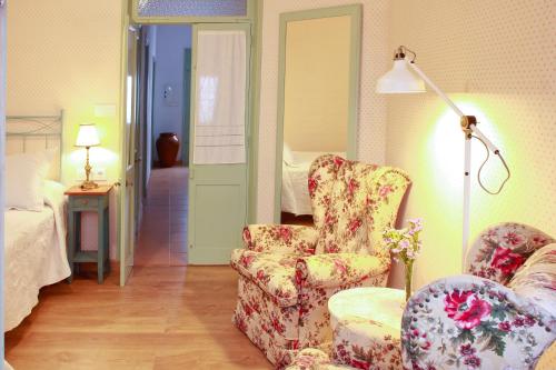 a room with a chair and a lamp and a bed at Es Badiu in Alaior
