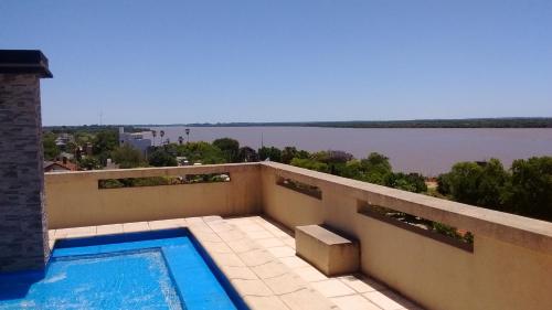 a swimming pool on a balcony with a view of the water at 11 Peyret Rent Aparts in Colón