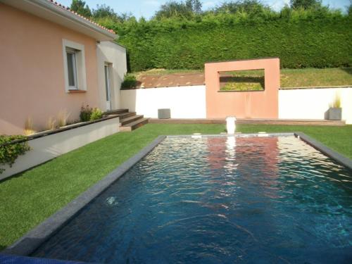 a swimming pool in the yard of a house at villa terrefort in Drémil-Lafage