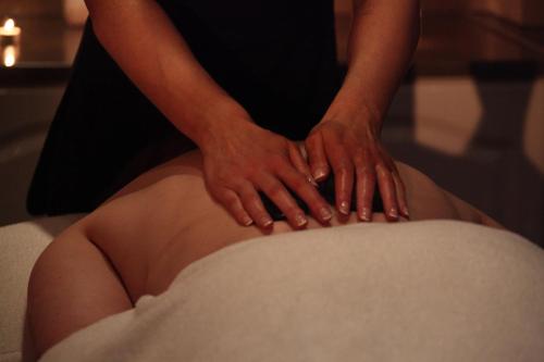 a woman with her hands on her stomach at Best Western Kings Manor in Edinburgh